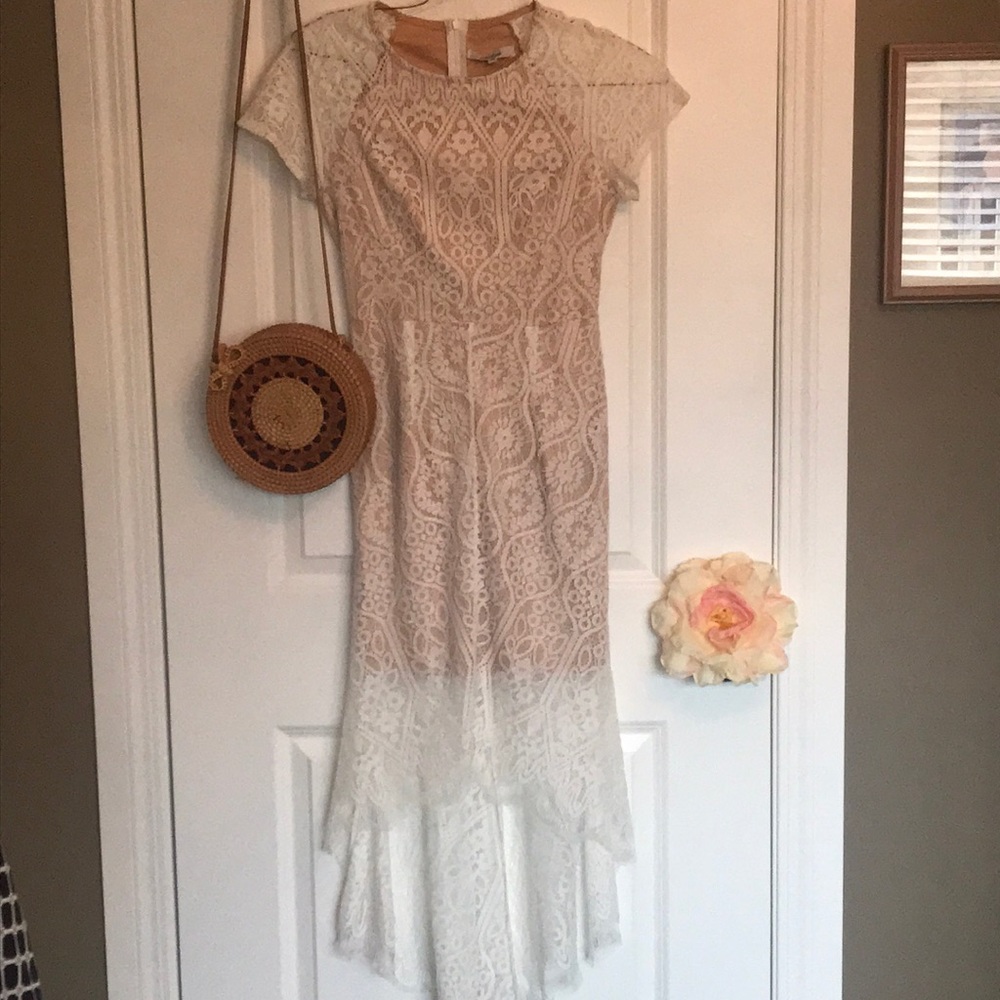 Fabulous lace dress. Short at front a d long at back. Light beige flesh lining.